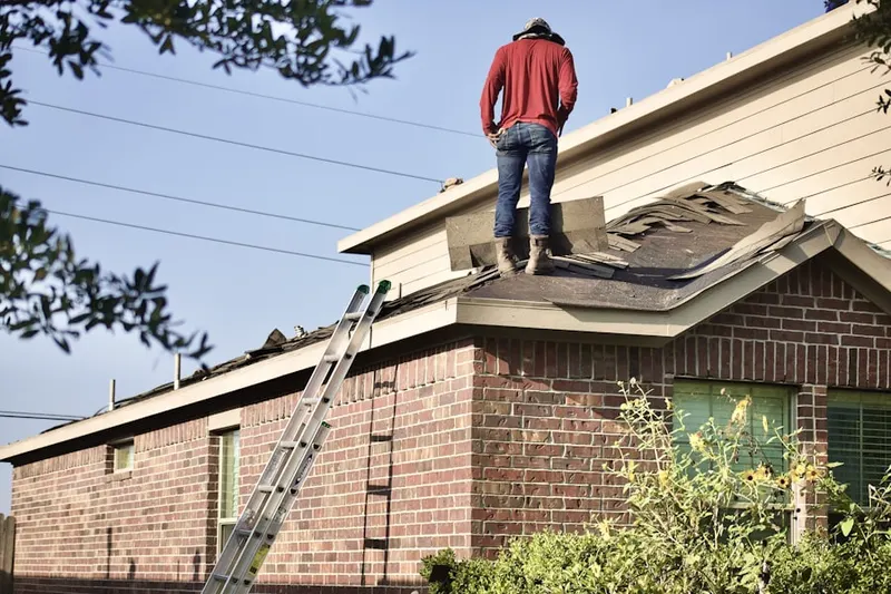 Professional roofer working on a residential roof in Wright Settlement